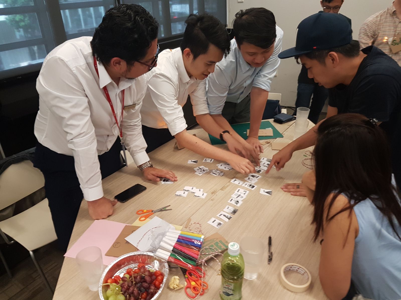 Teachers participating in a hands-on icebreaker activity at the start of a MakerEd Meetup session, setting the tone for collaborative learning.